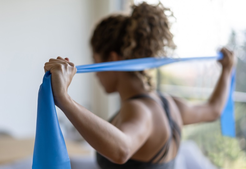 woman doing arm exercises with a resistance band