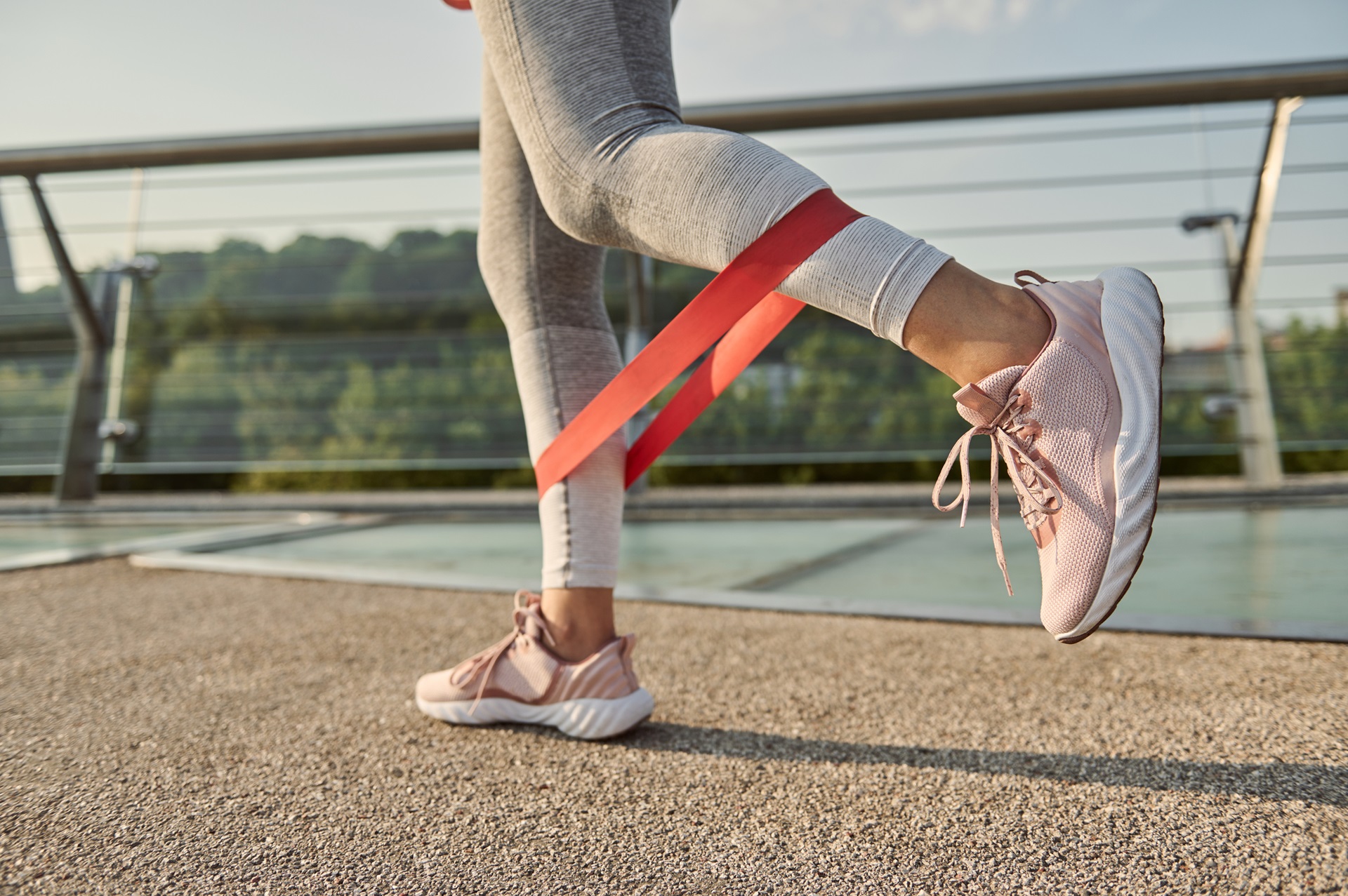 woman doing body weight training with a resistance fitness elastic bands