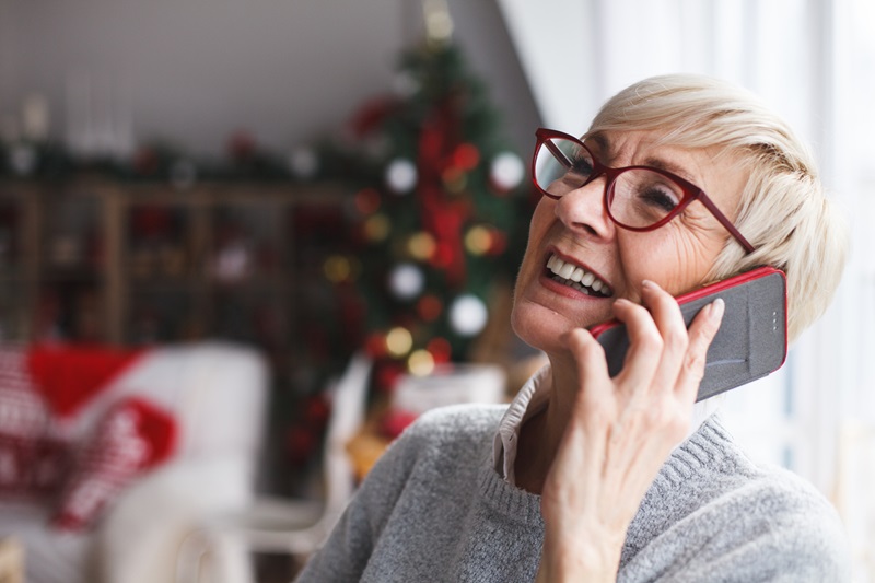 happy woman talking on the phone at Christmas time