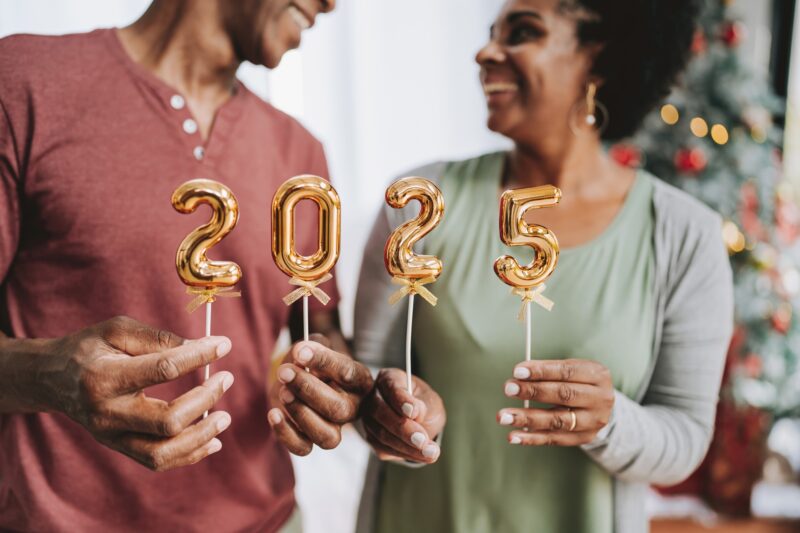 couple holding 2025 numbers for the new year