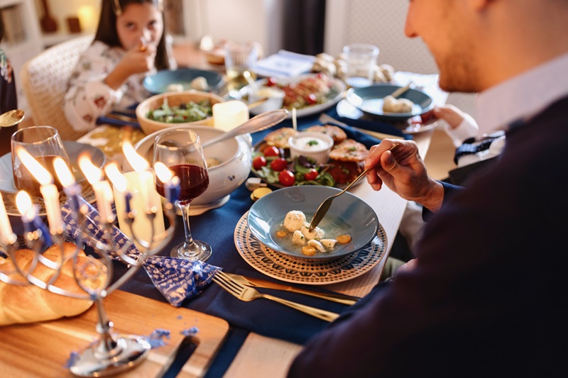 man eating a healthy holiday meal of Matzo Ball soup 