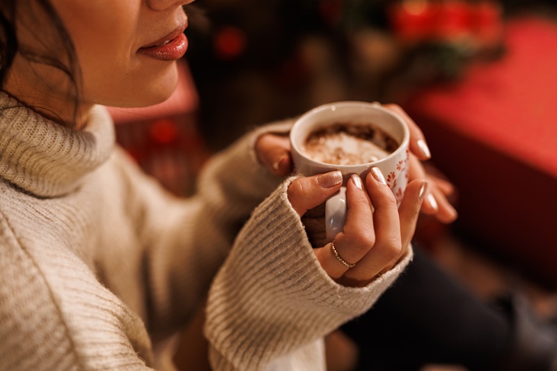 happy woman relaxing and enjoying hot chocolate