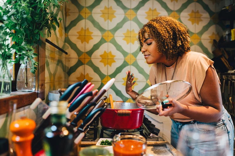 woman cooking at home investing in her hobby as a new years resolution idea