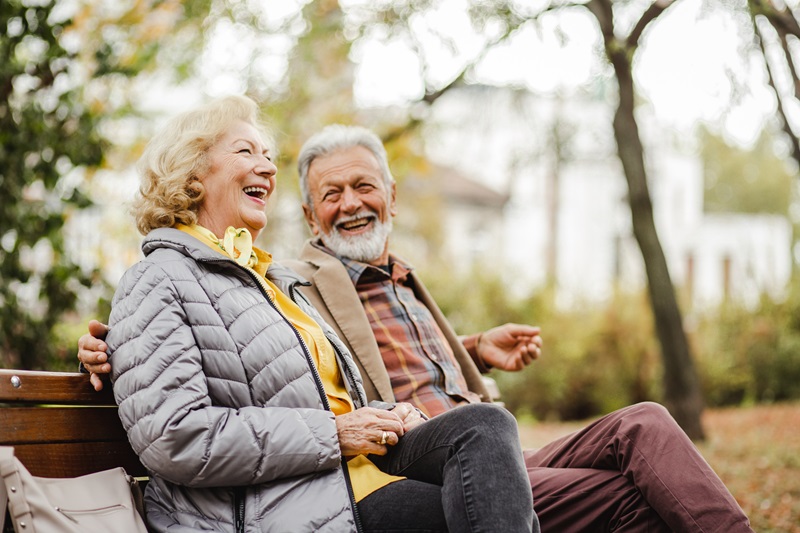 a stress free couple sitting outside laughing together