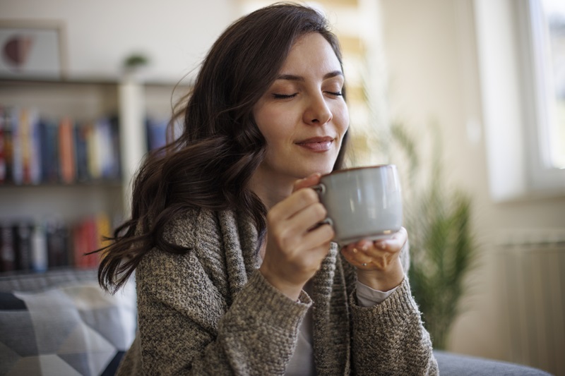 woman Relaxing during the holidays with a Soothing Cup of Tea