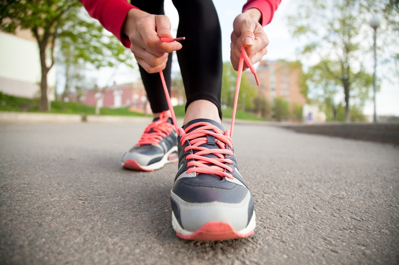 person tying shoes for a walk