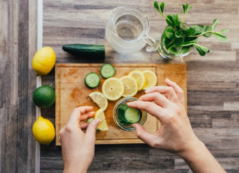 making infused water with lemon and cucumber and mint