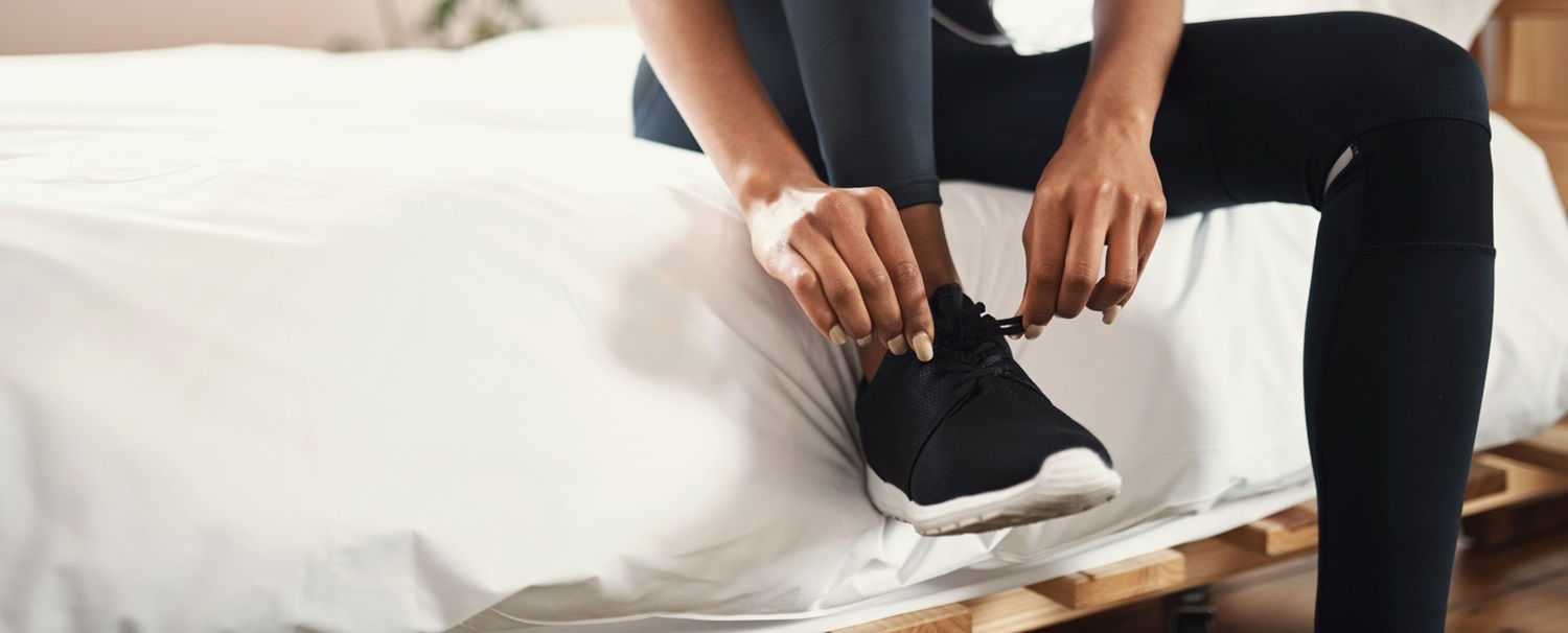 woman getting ready and putting on shoes for morning exercise workout