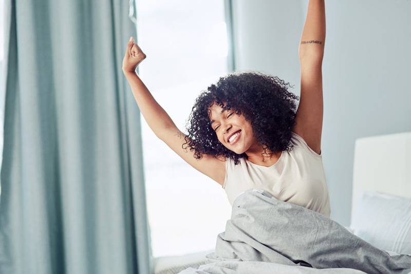 happy woman waking up early for morning exercise