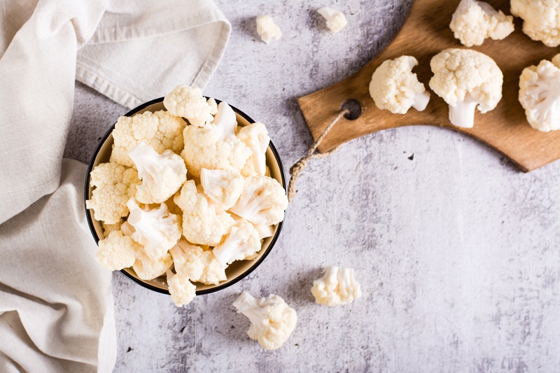 A bowl of raw cauliflower is on the table