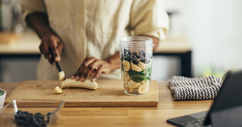 person making a spinach smoothie